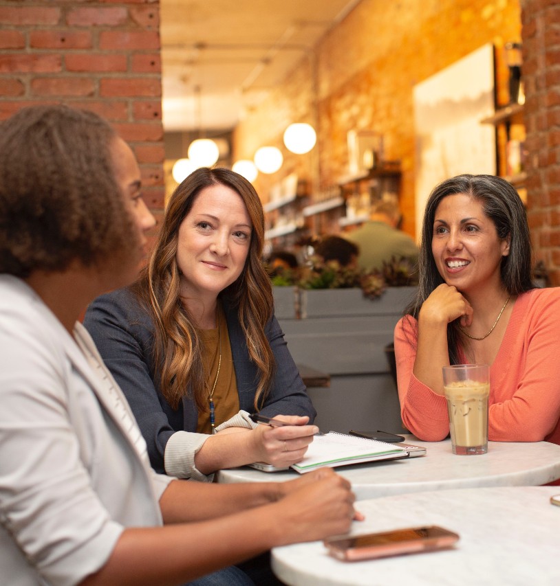 A group of women talking around a table