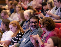 Conference attendees chatting in symposia