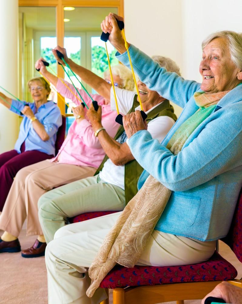 A group of elderly women exercising