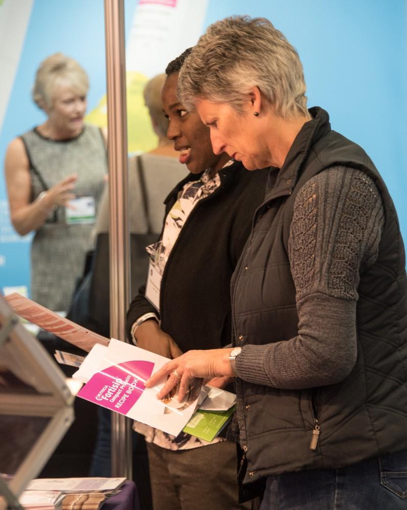 A group of delegates visiting an exhibitor