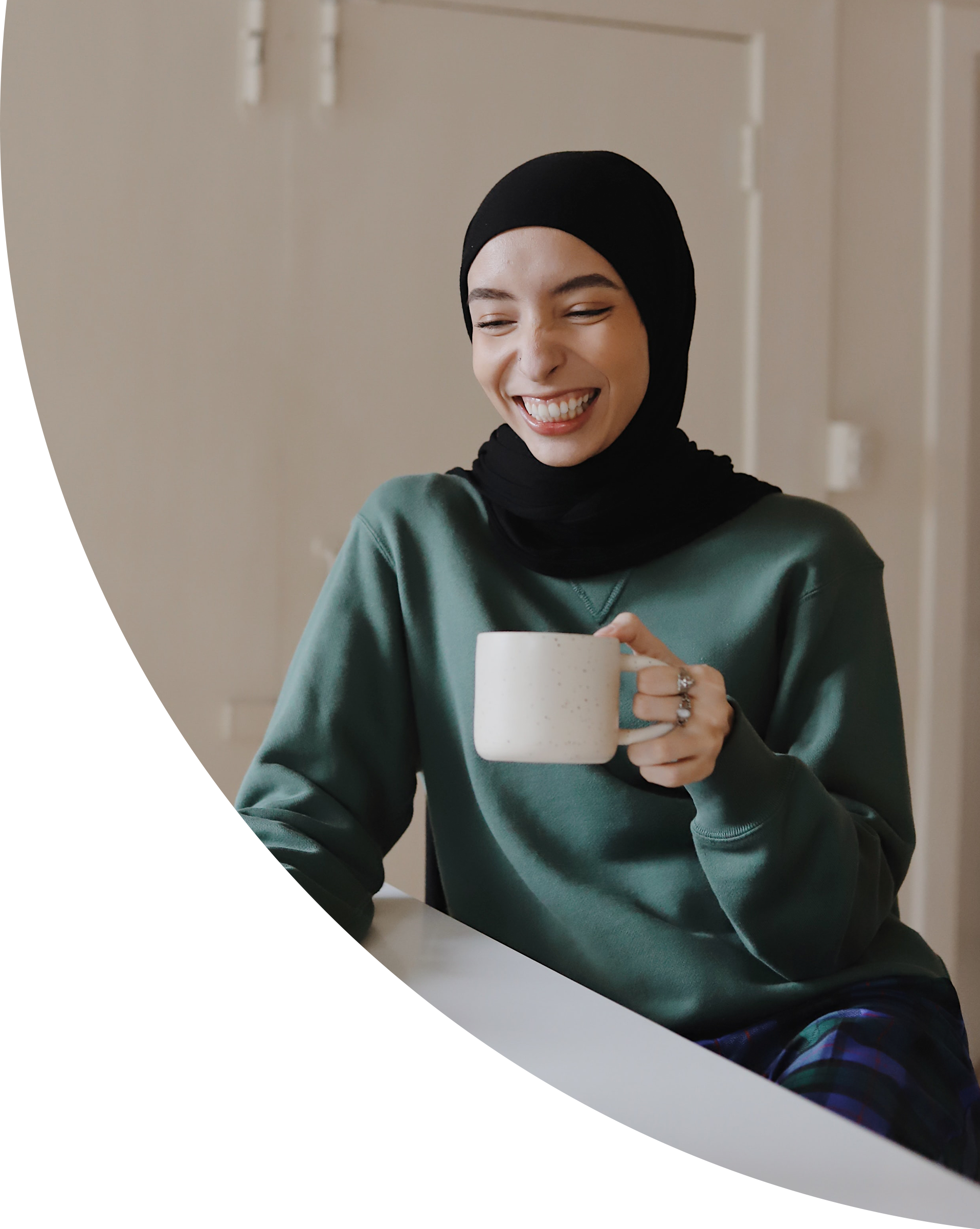 A woman on her laptop with a coffee