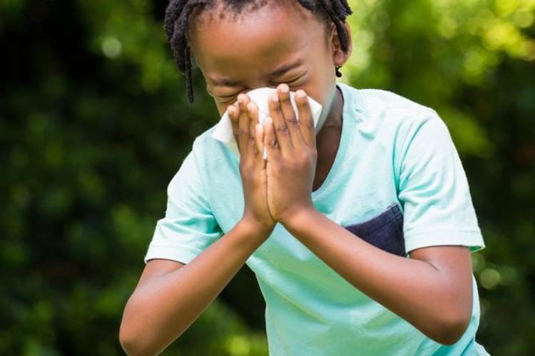 A boy sneezing