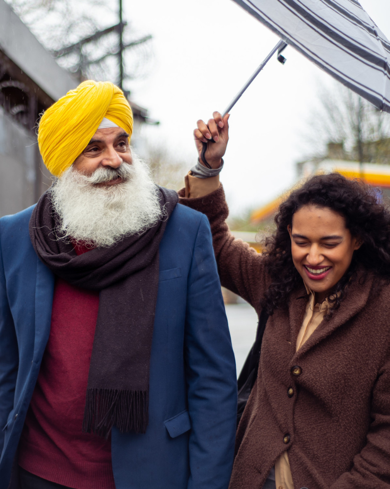 Man and woman going for a walk with umbrella