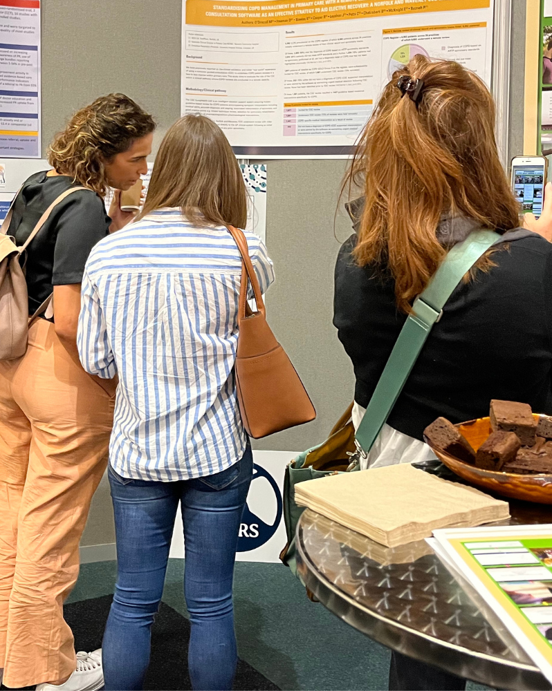 Conference attendees in discussion browsing abstract posters