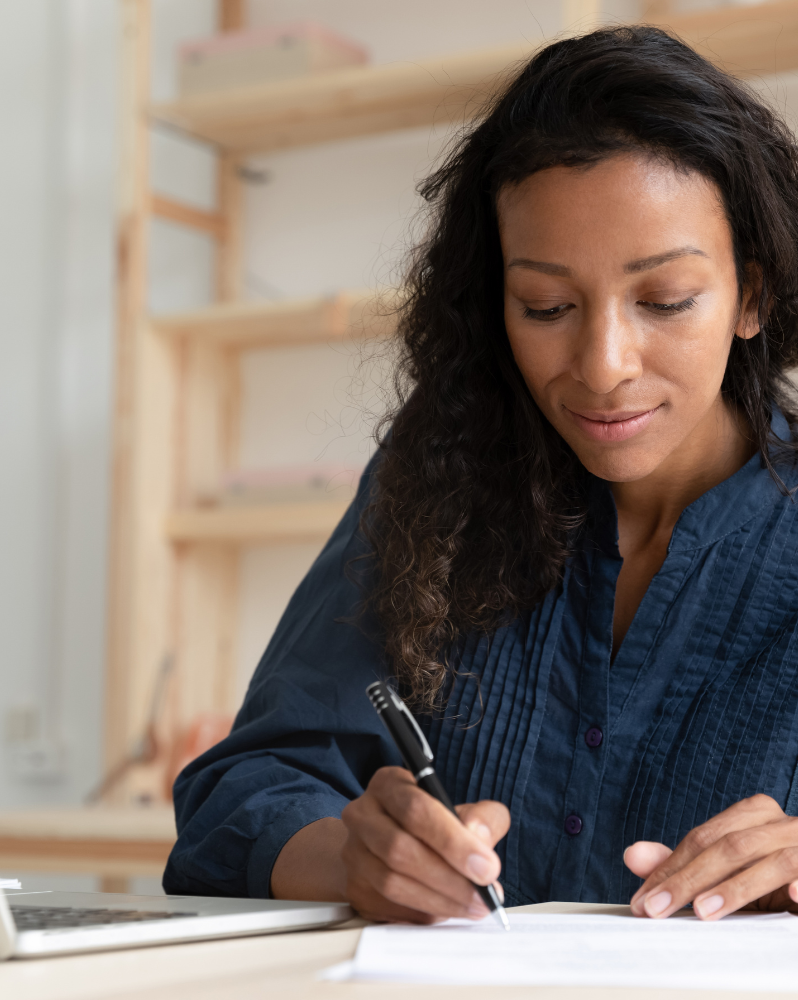 Woman taking notes during webinar