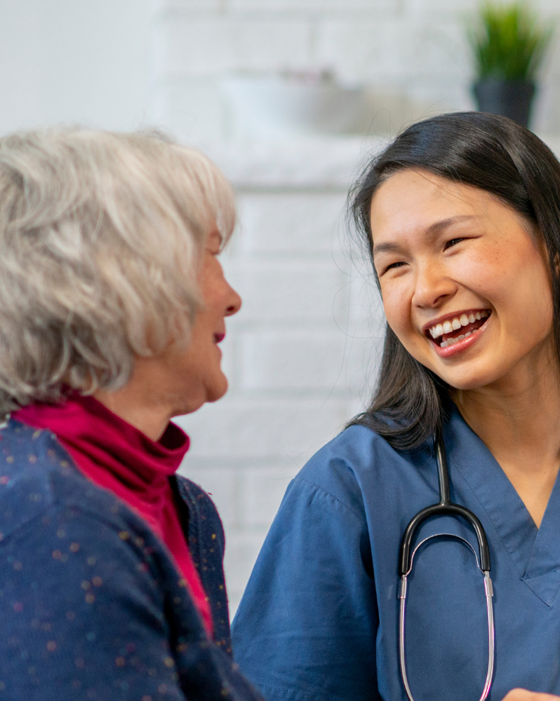 An NHS Nurse smiling and talking with a patient