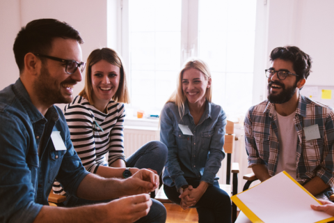 Group of men and women smiling and laughing together