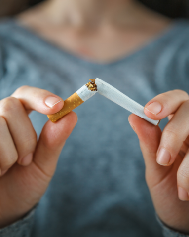 Snapped cigarette held in woman's hands